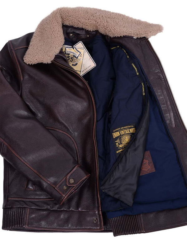Men's brown leather jacket with fur collar, unbuttoned, revealing removable dark blue lining.