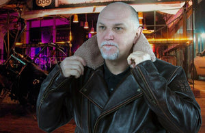 A man in a brown leather jacket.