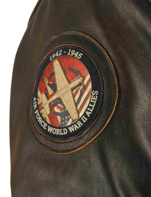 Round patch on the sleeve of a men's brown leather jacket.