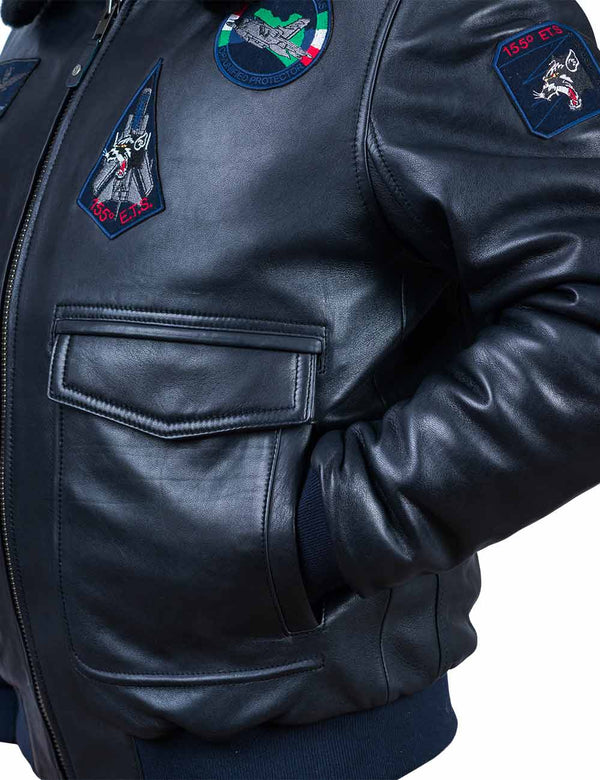 The left side of a dark blue leather jacket with the sleeve in the pocket.