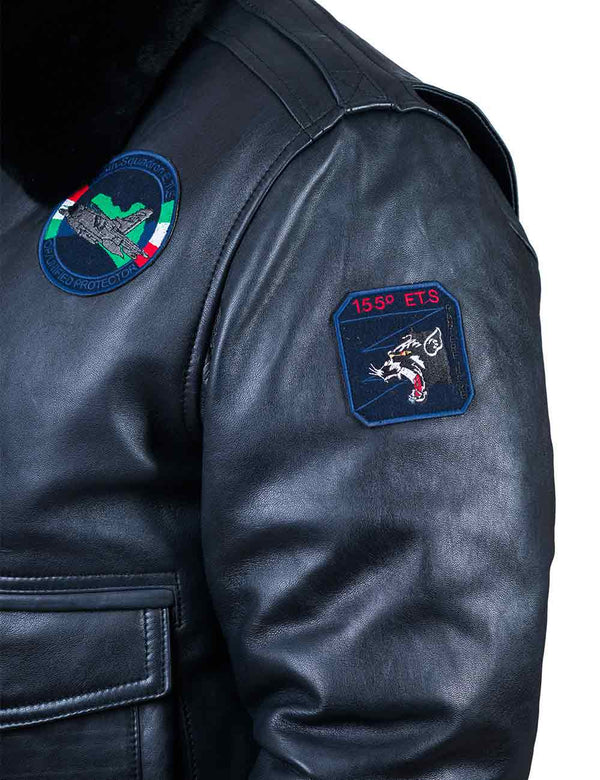 A square patch depicting a panther on the left sleeve of a dark blue leather jacket.