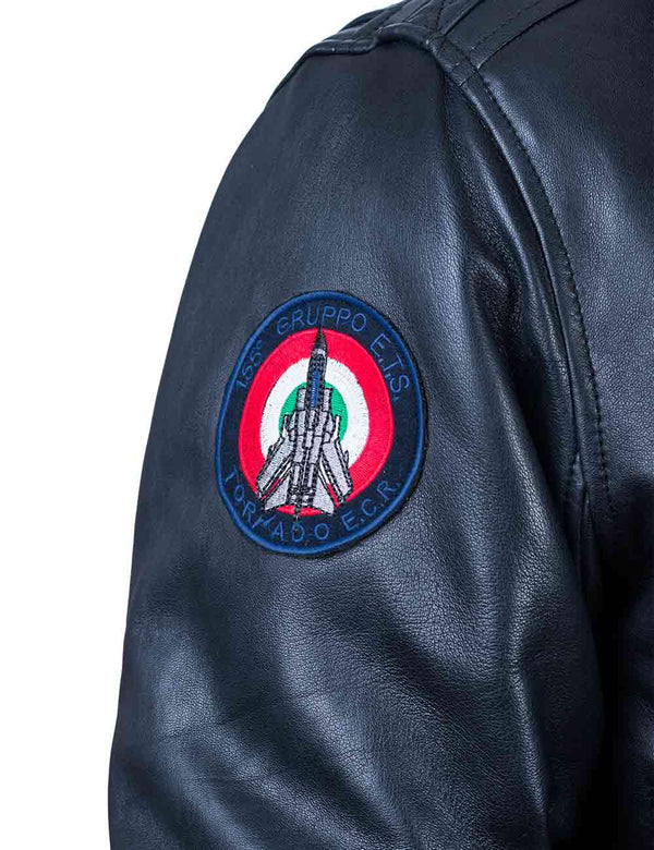 A patch on the sleeve of a dark blue leather jacket depicting a fighter jet.
