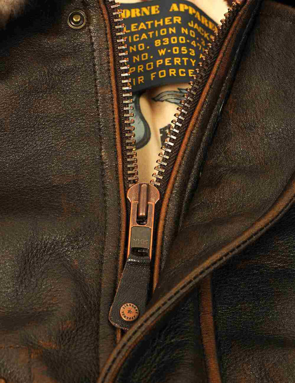 Metal zipper on a brown leather jacket.