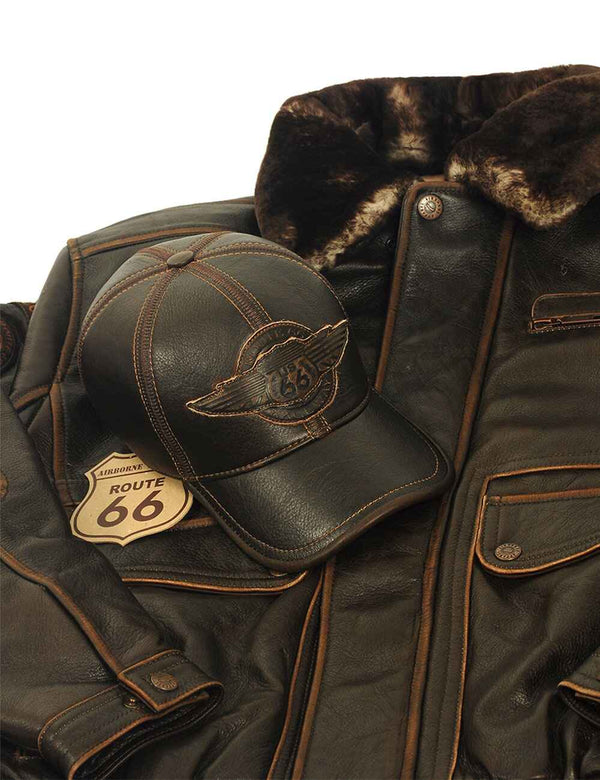 Brown leather men's jacket with sheepskin collar, a brown leather baseball cap is placed on the jacket.