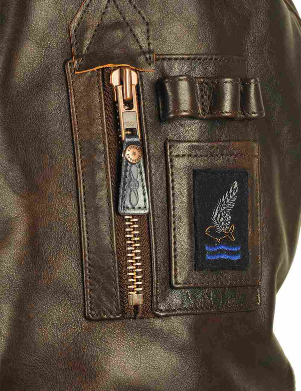 Utility pocket with patch on the sleeve of men's brown leather jacket.