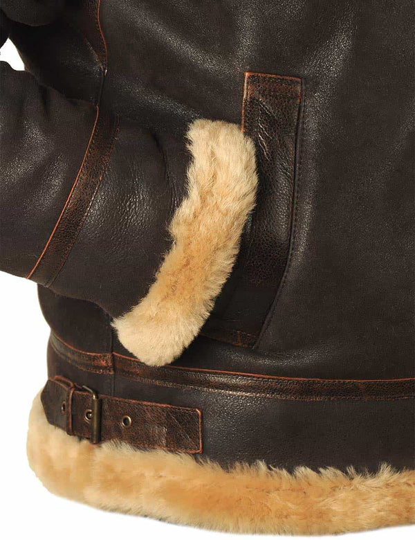 Lower right side of a men's brown sheepskin jacket with a sleeve in the pocket.