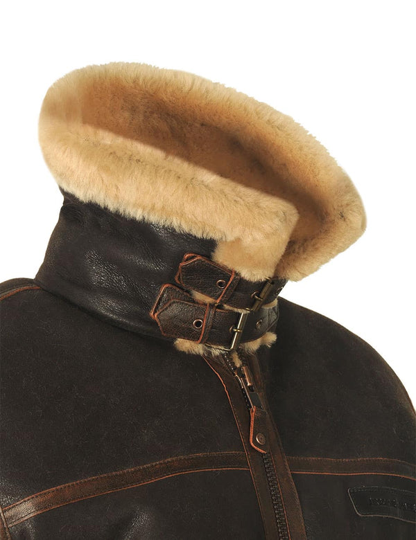 The top of a men's brown sheepskin jacket with the collar raised and fastened.