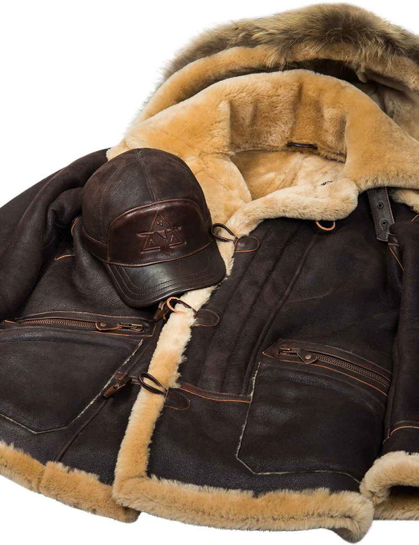 A brown men's fur-lined cap is placed over a brown men's sheepskin coat.