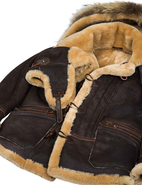A brown men's ushanka hat is placed on top of a brown men's sheepskin jacket.