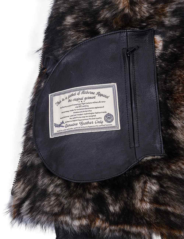 The inner fur part of a black leather jacket with a patch on the inner pocket.