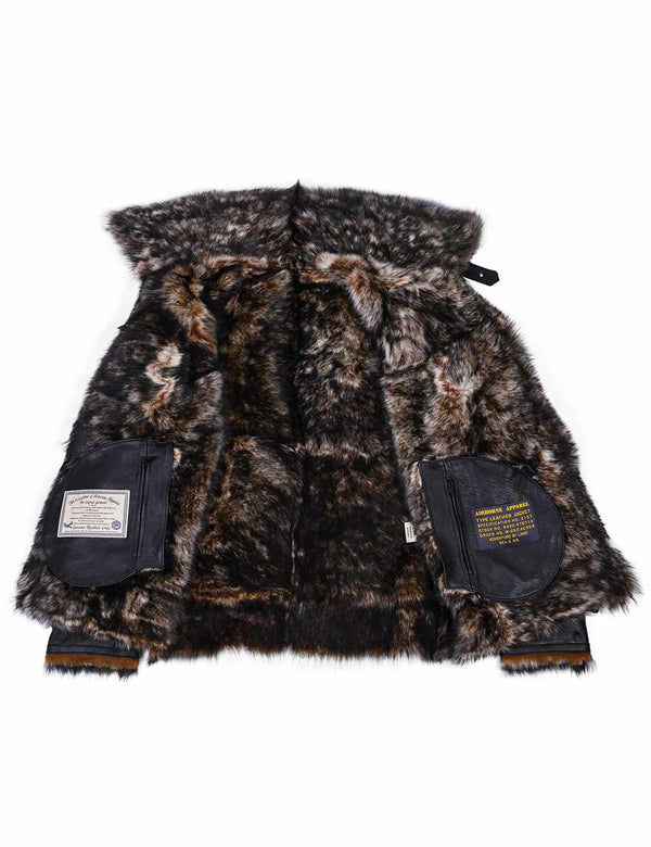 The inner fur part of a black leather jacket with patches on the inner pockets.
