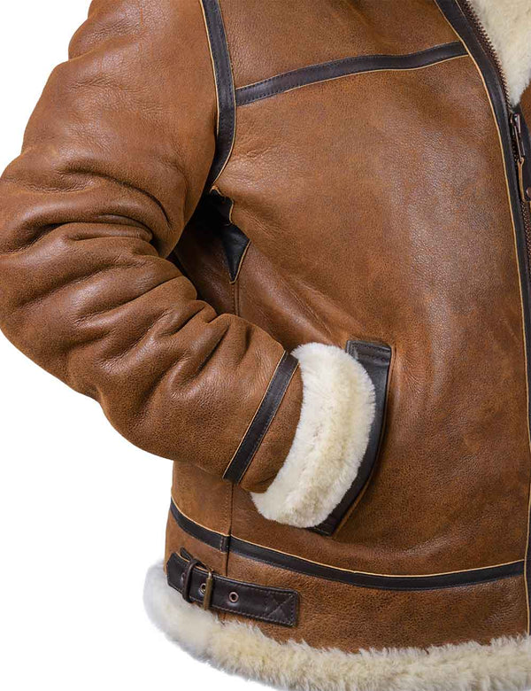 Right side of an orange sheepskin jacket with the sleeve in the pocket.