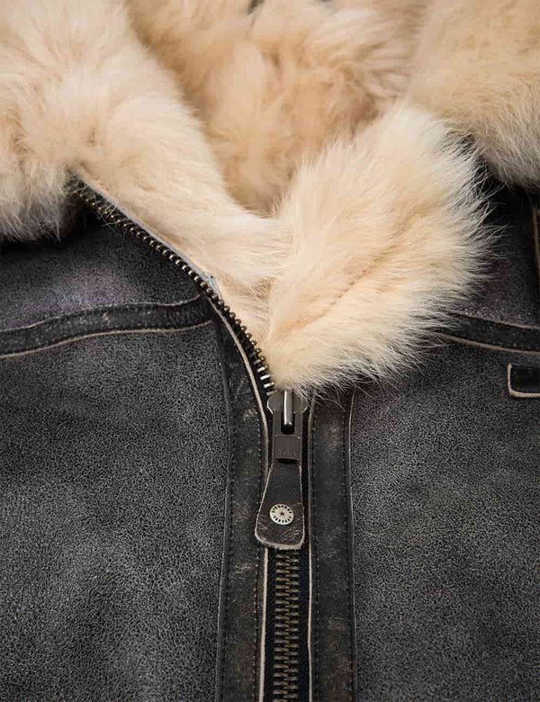 Zipper on a grey sheepskin jacket with light fur.