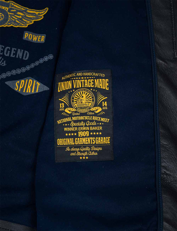 A bright patch on the blue lining of a black leather jacket.