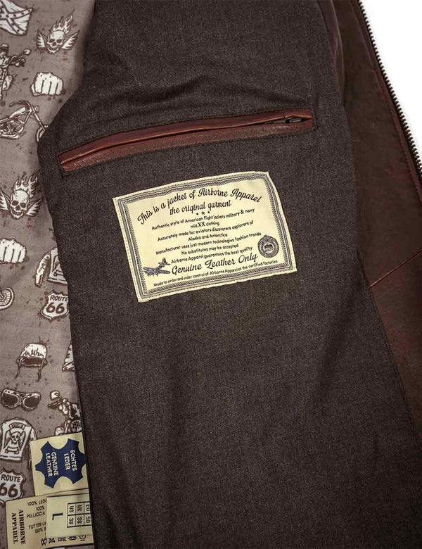 Brown leather jacket with a label on a patterned background.