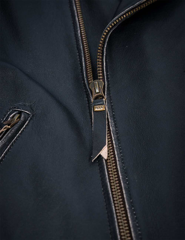 Metal zipper with a pendant on the black leather jacket.