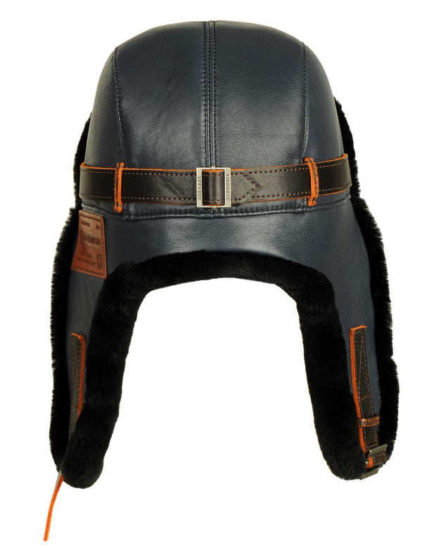 Men's leather trapper hat with sheepskin lining, navy blue with brown straps and patch, back view.