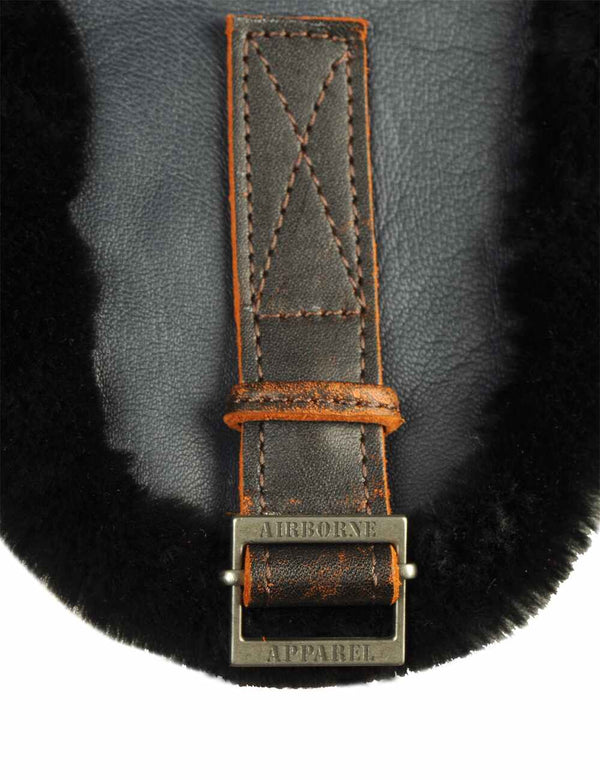 Metal clasp with branded logo on the ear of the trapper hat
