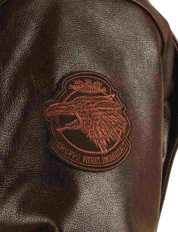 A patch on the left sleeve of a brown men's leather jacket.