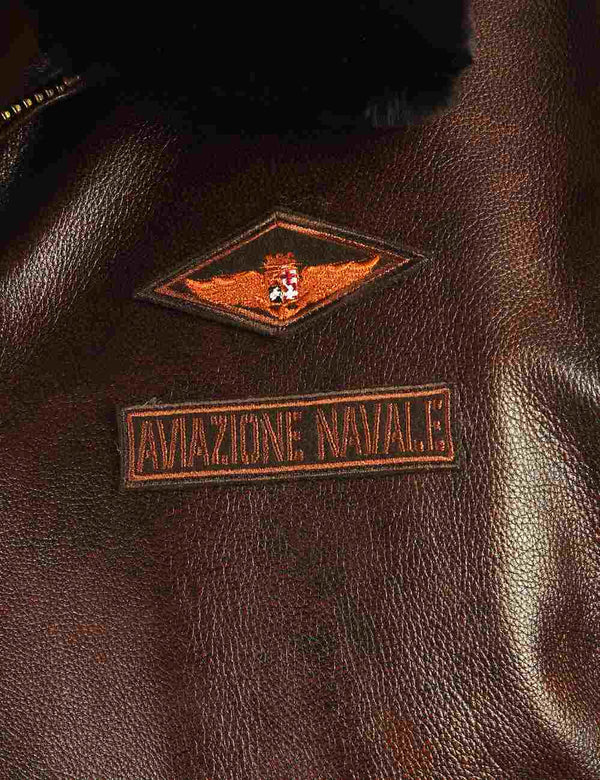Patches on the chest of a brown men's leather jacket.