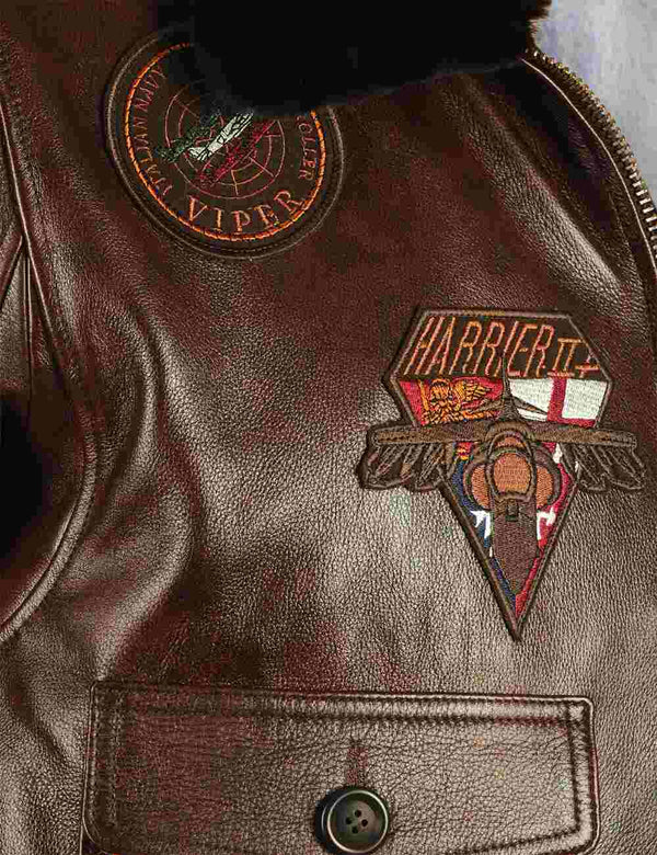 Patches on the chest of a brown men's leather jacket.