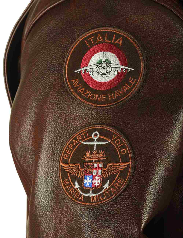 Patches on the right sleeve of a brown men's leather jacket.