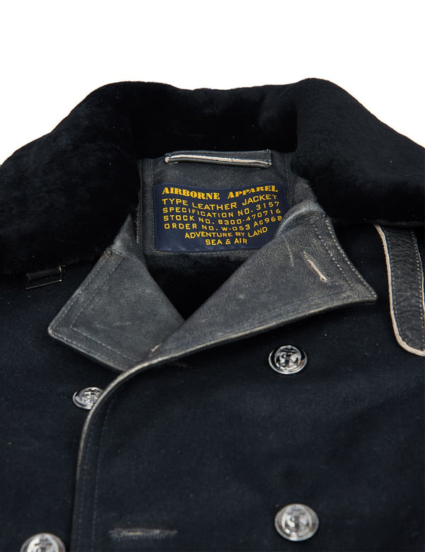 Part of a men's black pea coat.