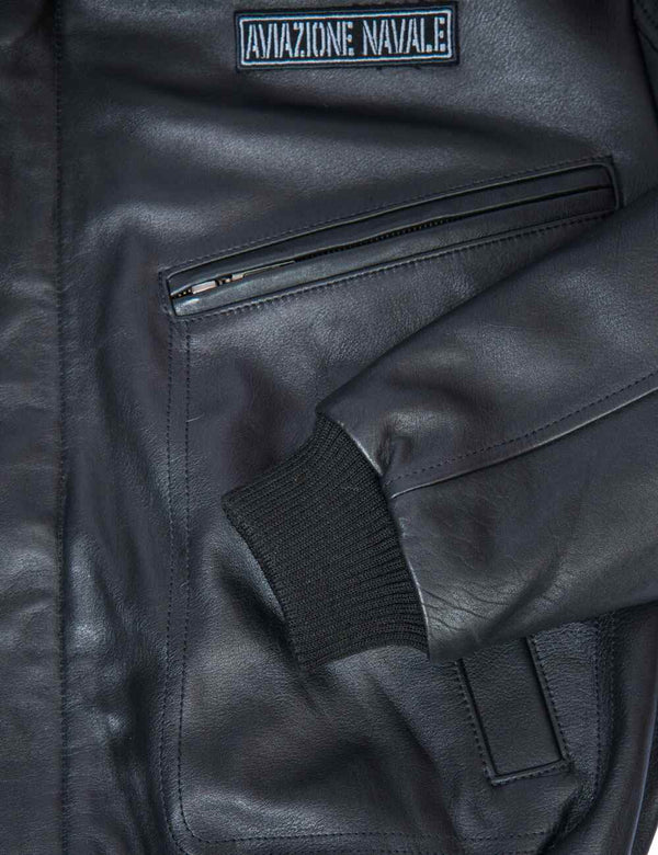 Pocket and part of the sleeve of a black men's leather jacket.