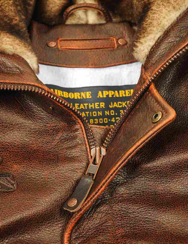 Metal zipper of a brown men's leather jacket.