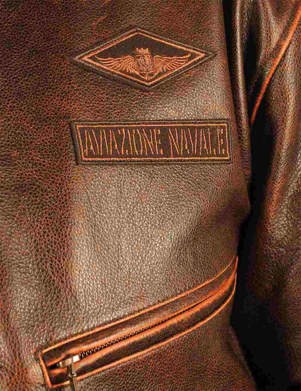 Patches on the chest of a brown men's leather jacket.
