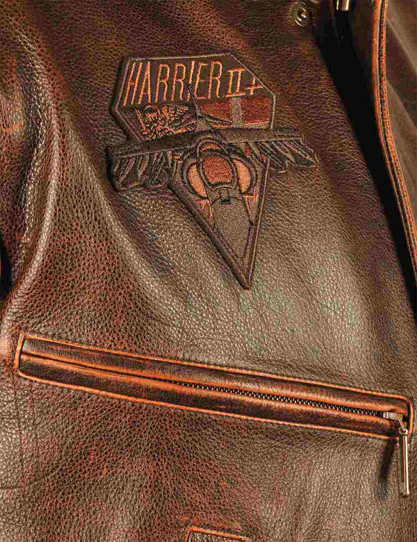 A patch on the chest of a brown men's leather jacket.