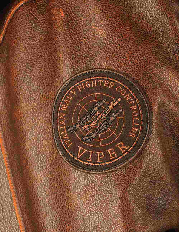 A round patch on the right sleeve of a brown men's leather jacket.