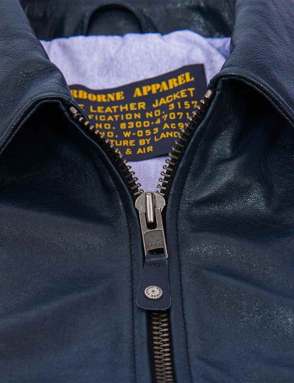 Metal zipper of a men's dark blue leather jacket.