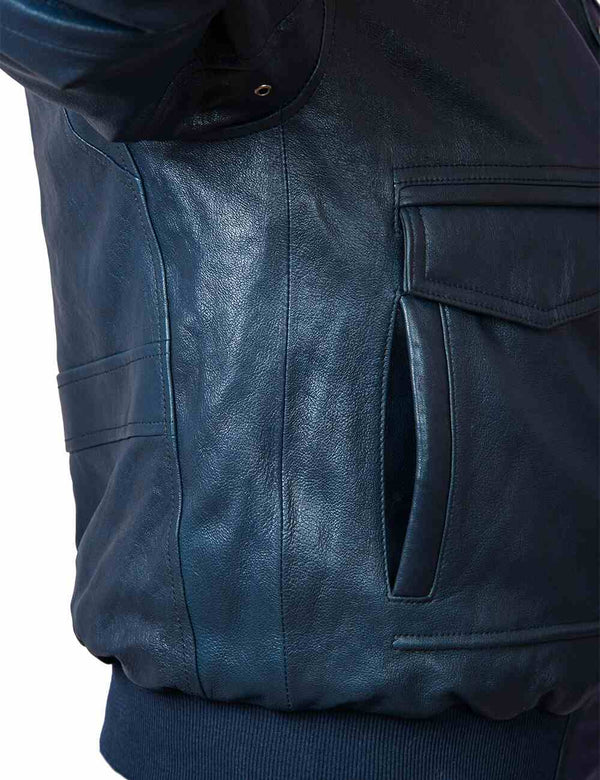 The armpit area of a dark blue men's leather jacket.