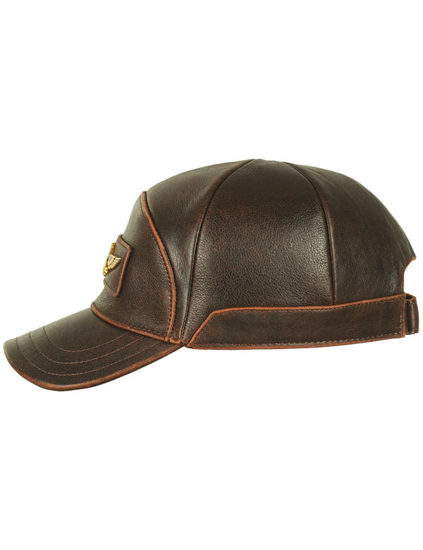 Brown leather men's cap with gold metal emblem on the forehead, side view.