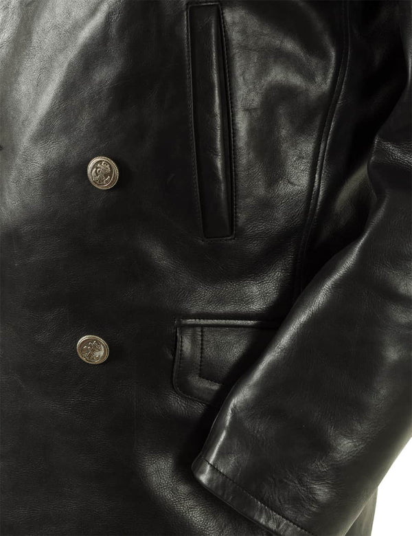 Pockets and part of the sleeve of a men's black leather pea coat.