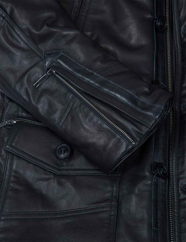 Metal zipper on the sleeve of a black leather jacket.