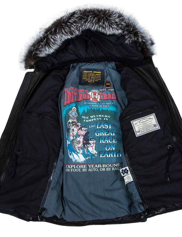 The inner part with lining of a black leather men's jacket with a hood trimmed with silver fox fur.