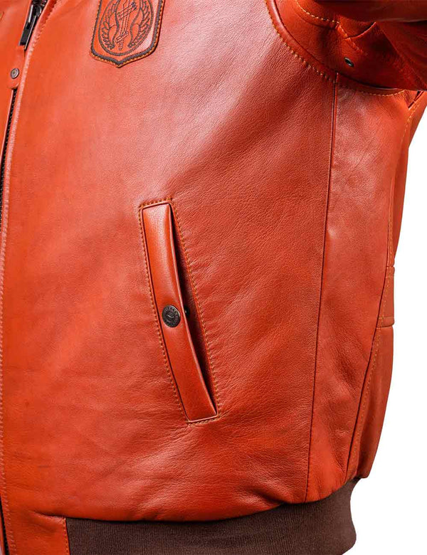 Vertical left pocket with button on orange leather jacket.