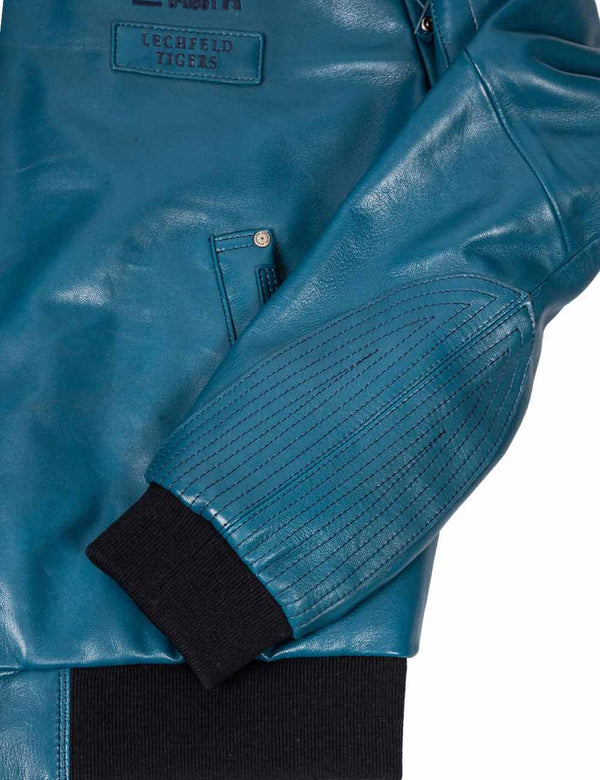 Processing the sleeve of a lagoon blue leather jacket.