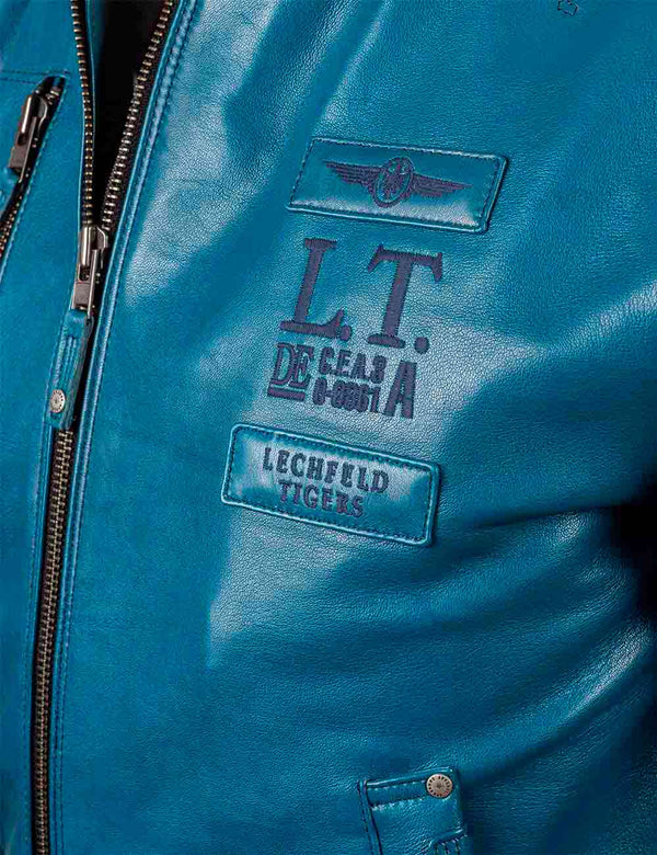 Patches on the chest of a men's lagoon blue leather jacket.
