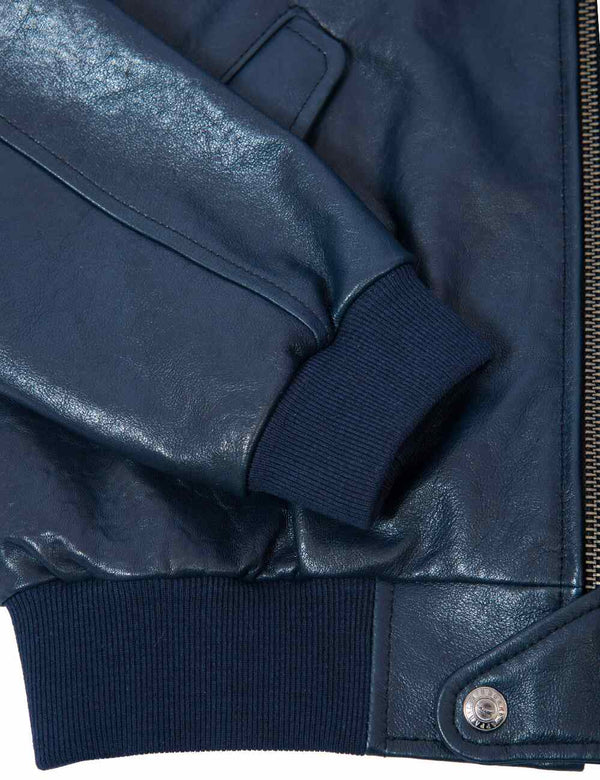 Knitted cuff and elastic waistband on a dark blue men's leather jacket.