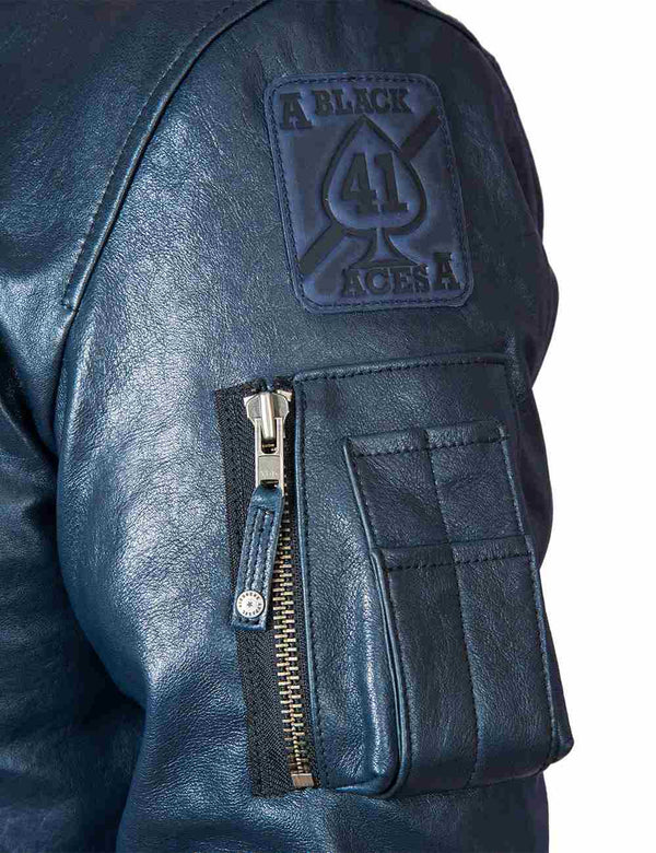Utility pocket and patch on the sleeve of a dark blue men's leather jacket.