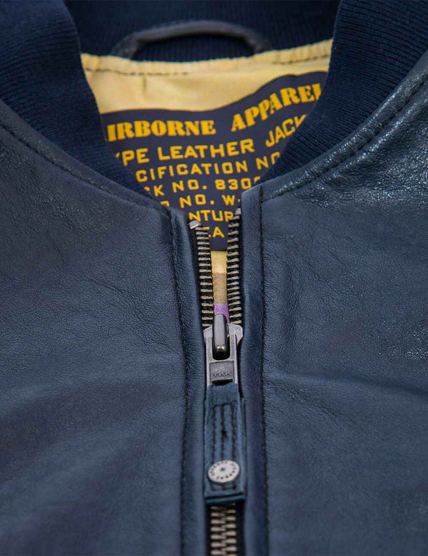 Metal zipper on a dark blue men's leather jacket.