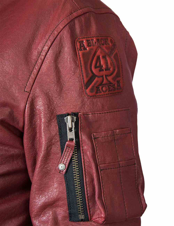 The utility pocket and a patch on the sleeve of a men's bordo leather jacket.