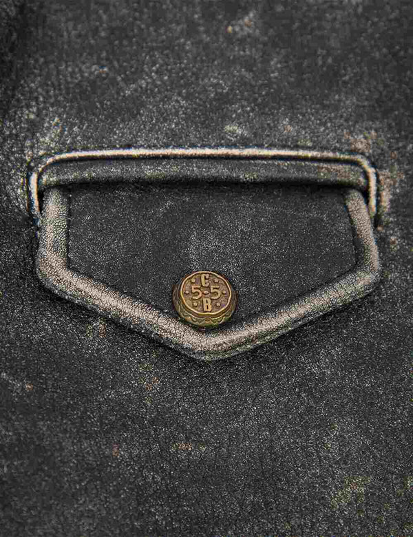 A Flap pocket with a button on the black women's leather jacket with bleached seams.