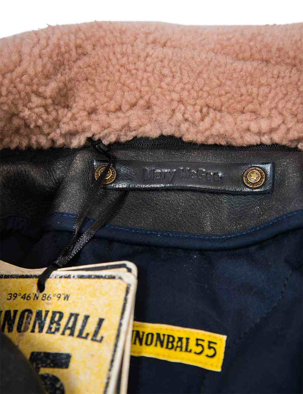 Tag and fur collar of a black leather jacket.
