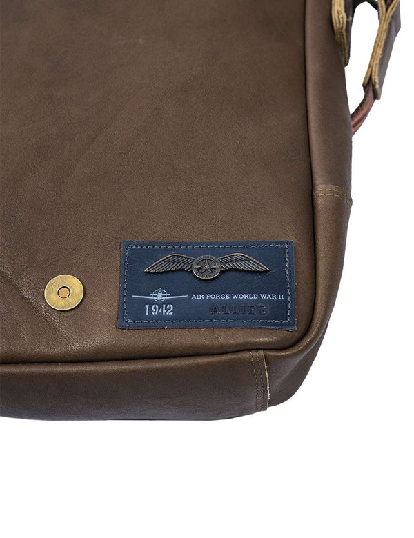 Patch on a men's olive leather bag.