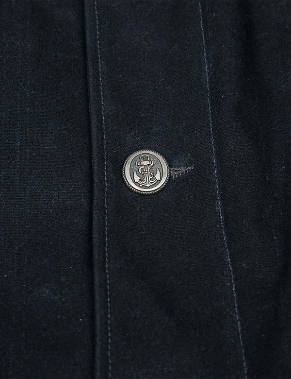 Button of a men's black pea coat.