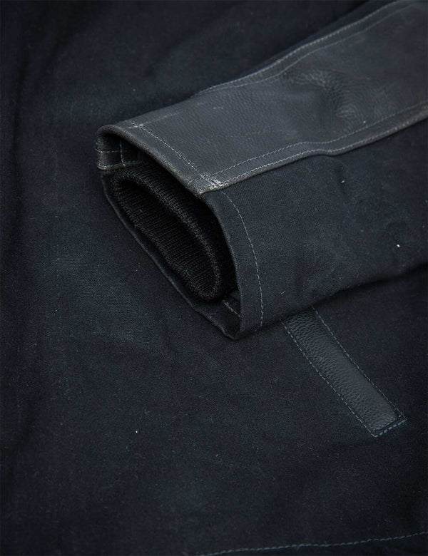 Sleeve of a men's black pea coat.
